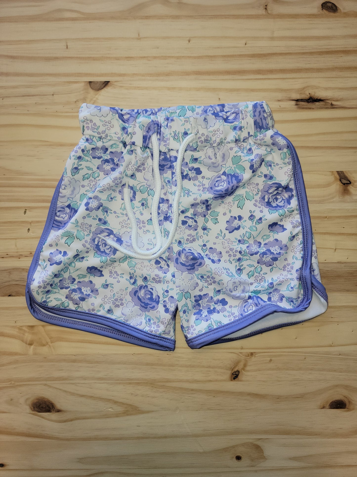 Girls drawstring shorts with purple floral print, featuring pockets