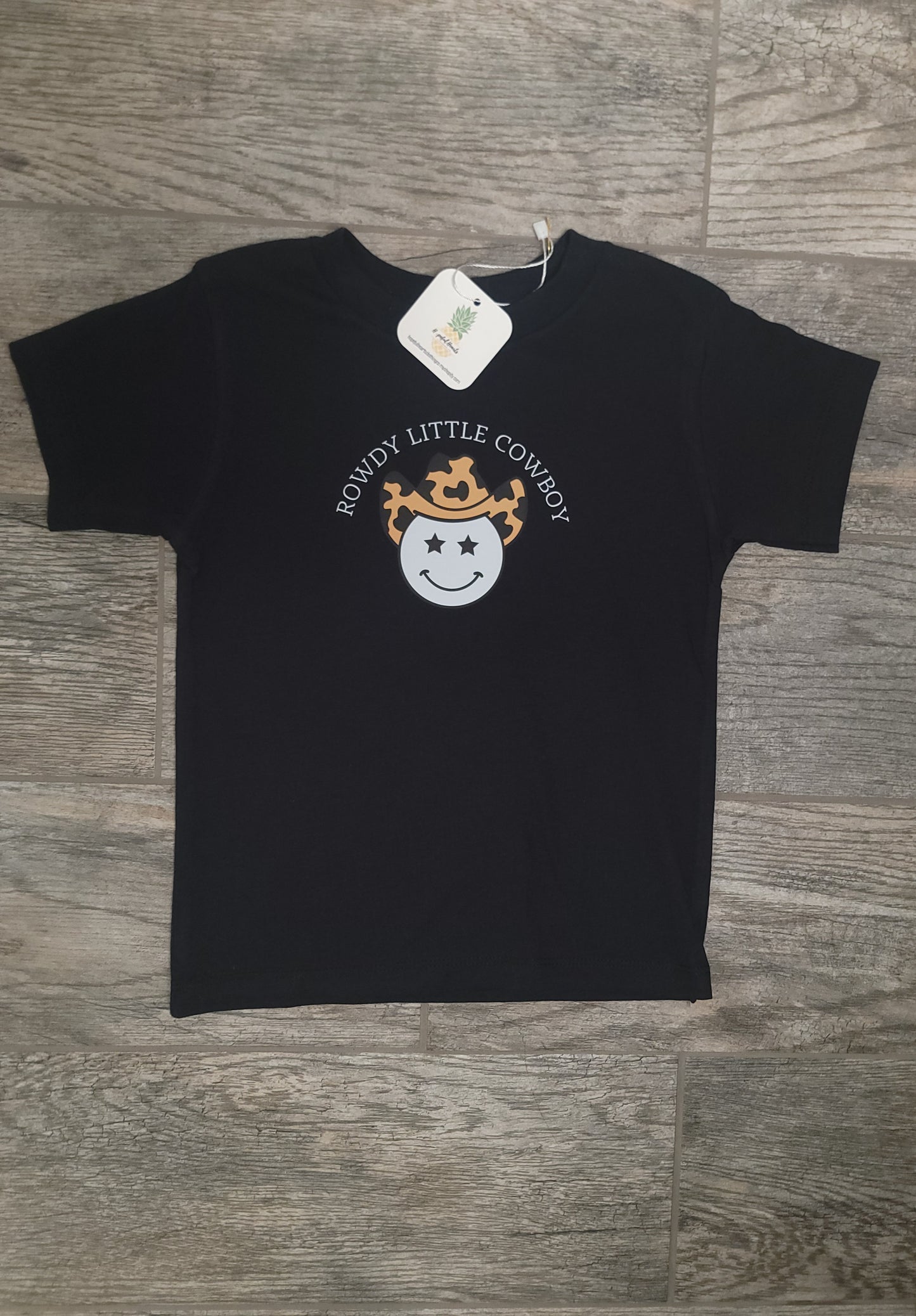 Flat lay of Rowdy Cowboy Tee for infants and toddlers, soft cotton western-themed shirt with playful cowboy graphic