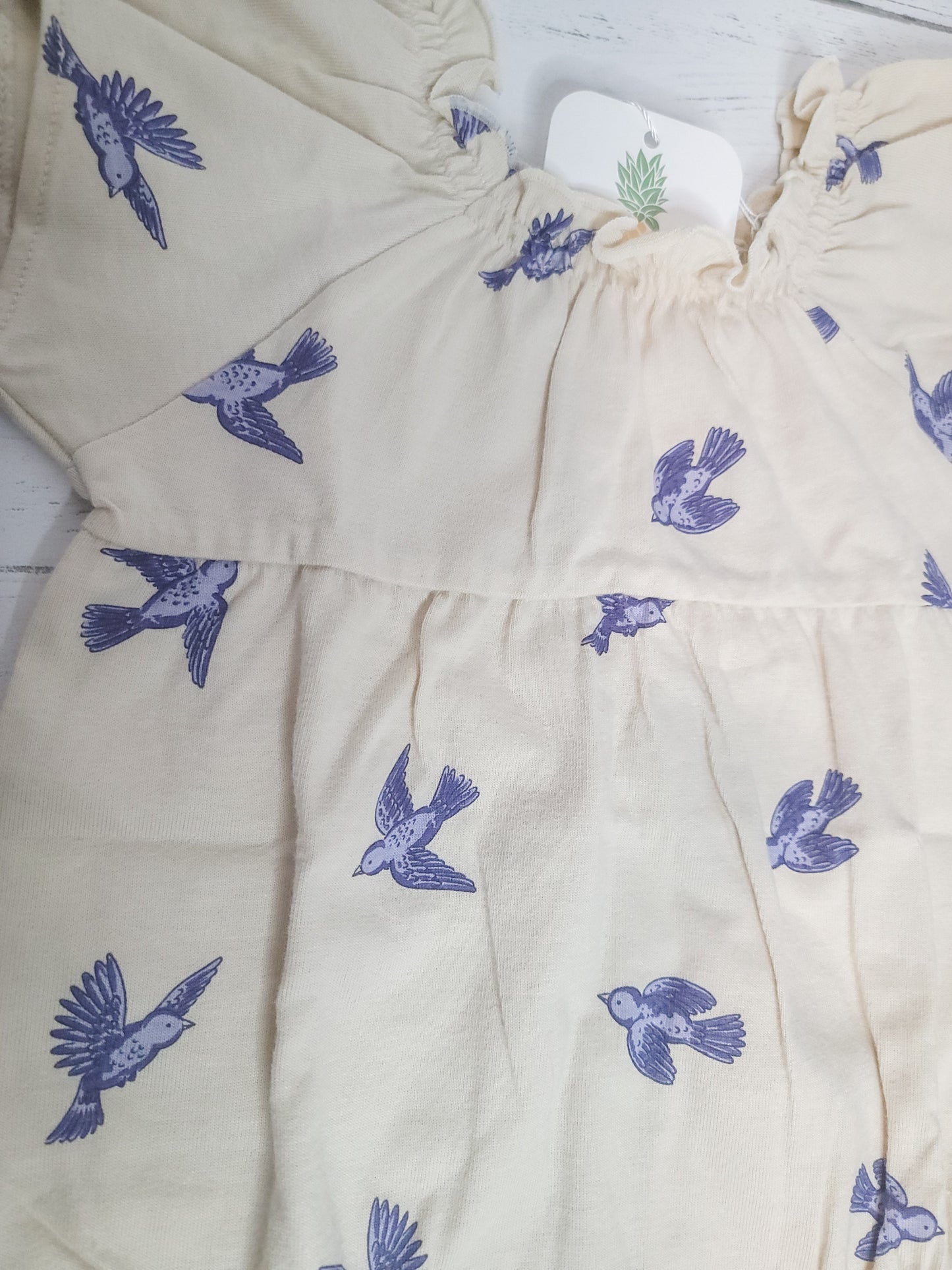 Close-up flat lay of Bluebird Flutter Sleeve Romper, highlighting flutter sleeve detail and cotton texture