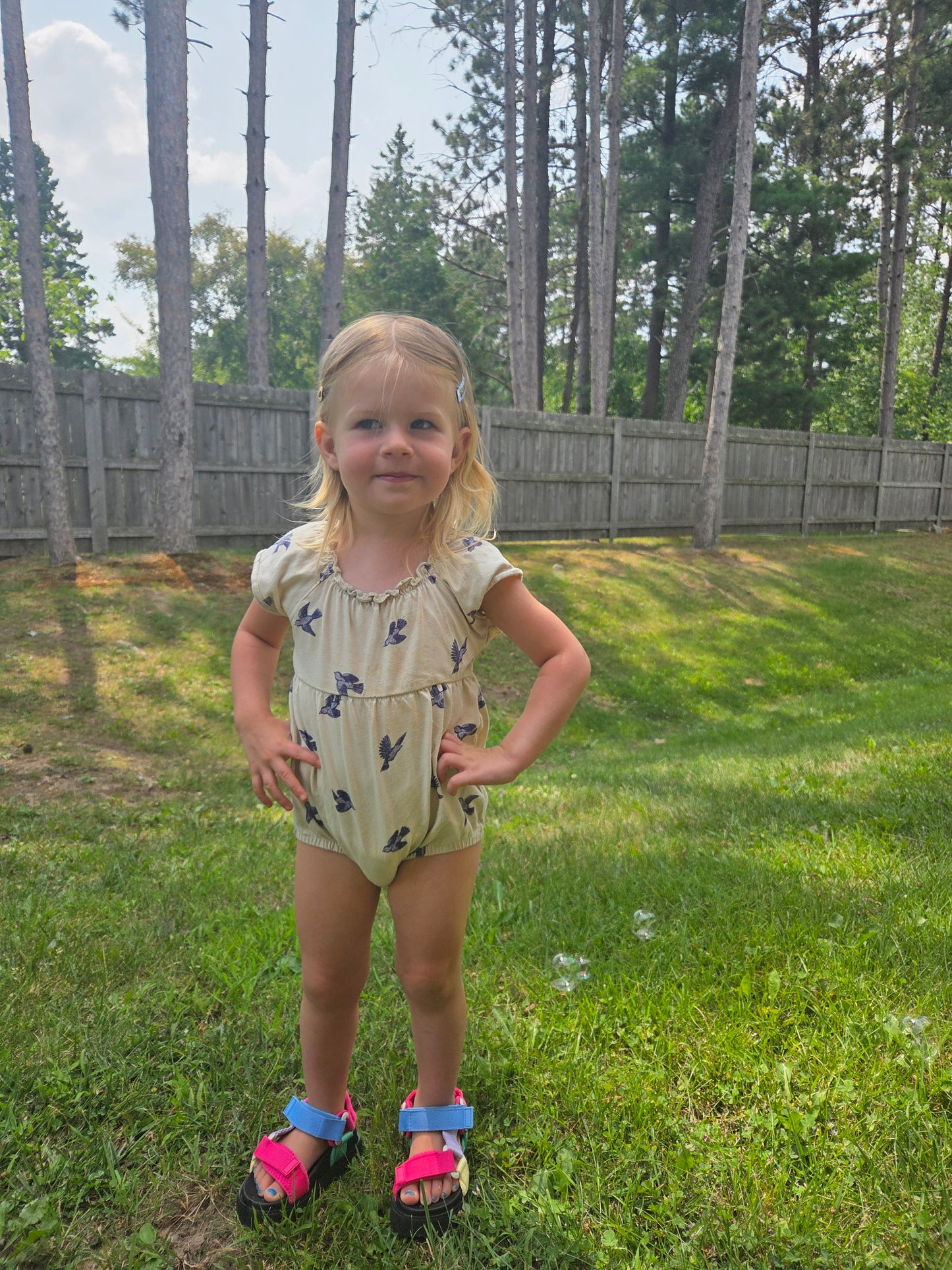 Toddler wearing Bluebird Flutter Sleeve Romper, front view, lightweight cotton, perfect for play and comfort