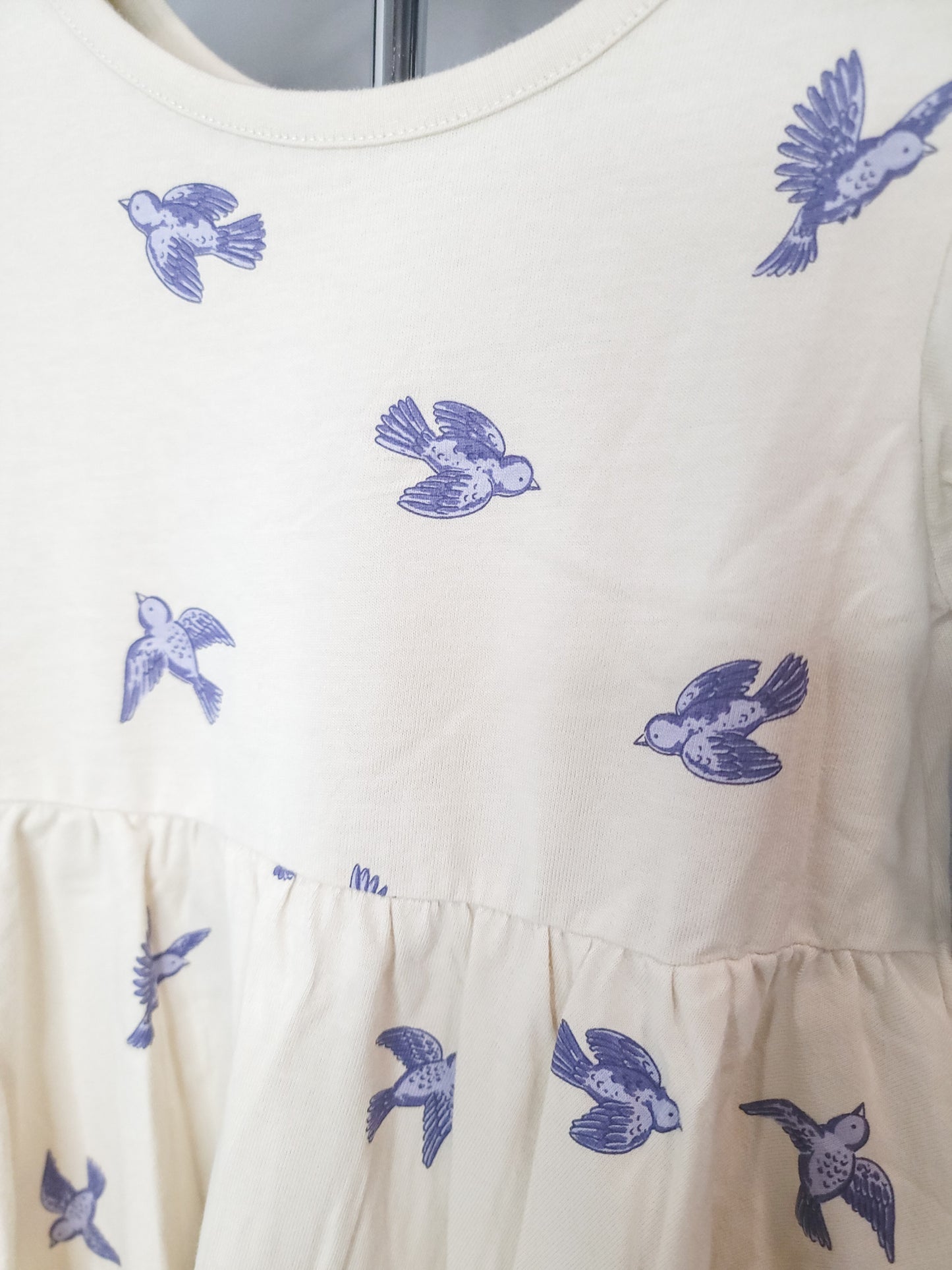 Close-up of Bluebird Twirl Dress for toddler girls, showing cotton fabric, stitching, and twirl-friendly skirt detail