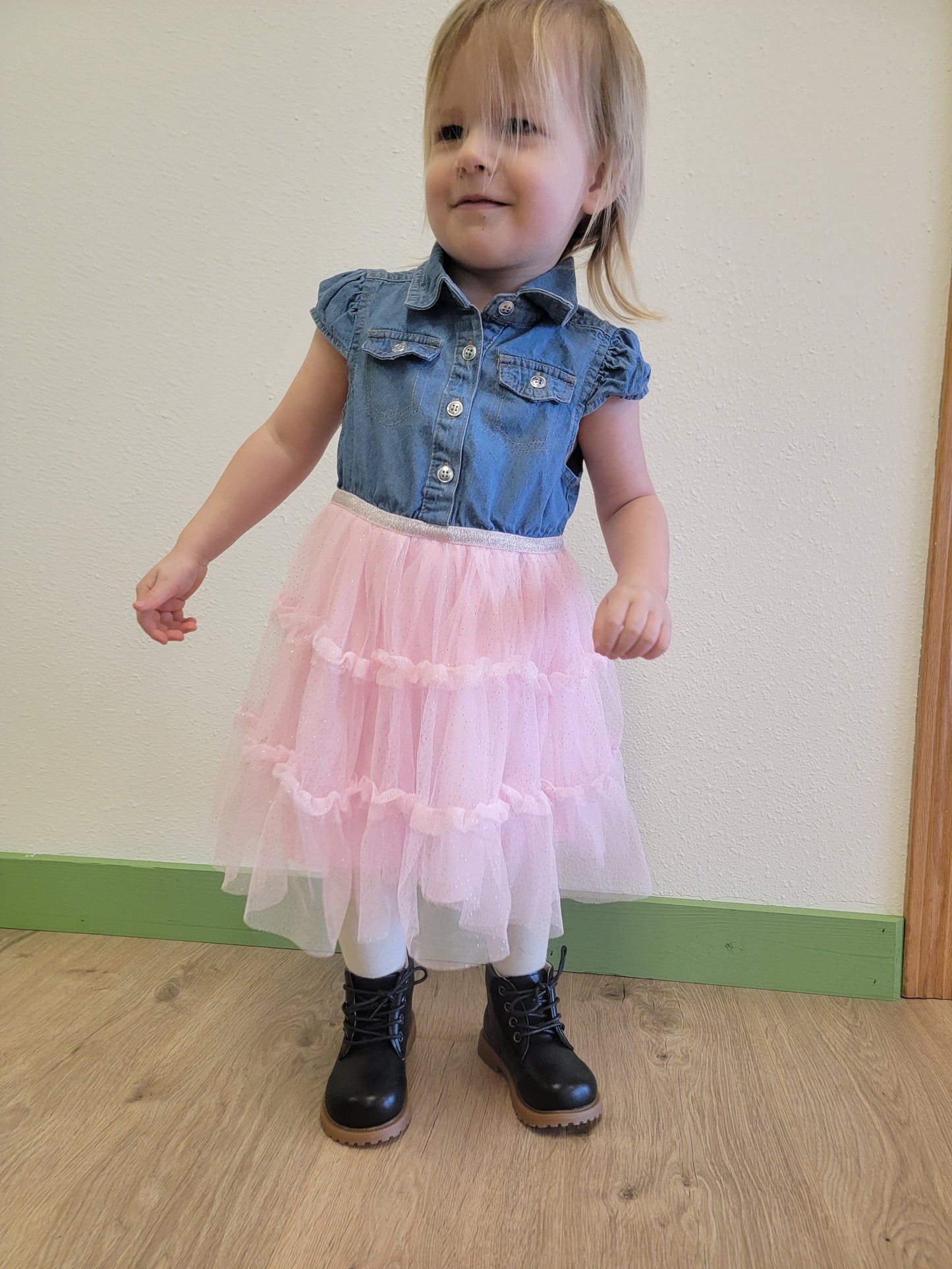 Toddler wearing black unisex combat boots, showing fit, lace-up design, and comfort for active wear