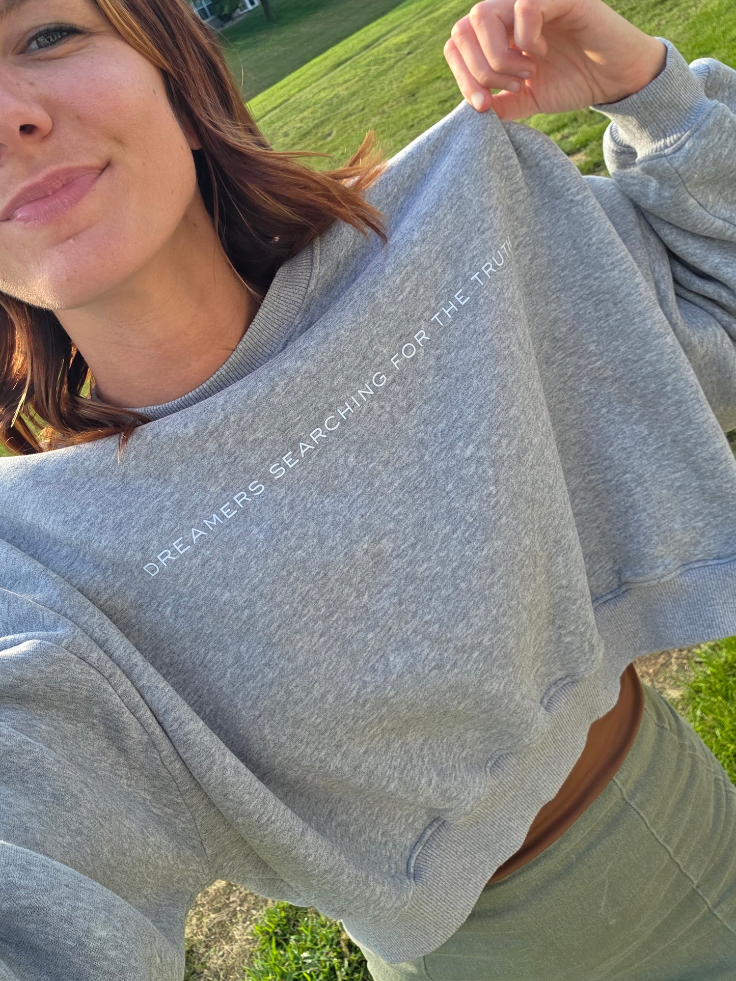 Front view selfie of woman wearing Dreamers Searching for the Truth oversized crop crewneck, cozy and casual”