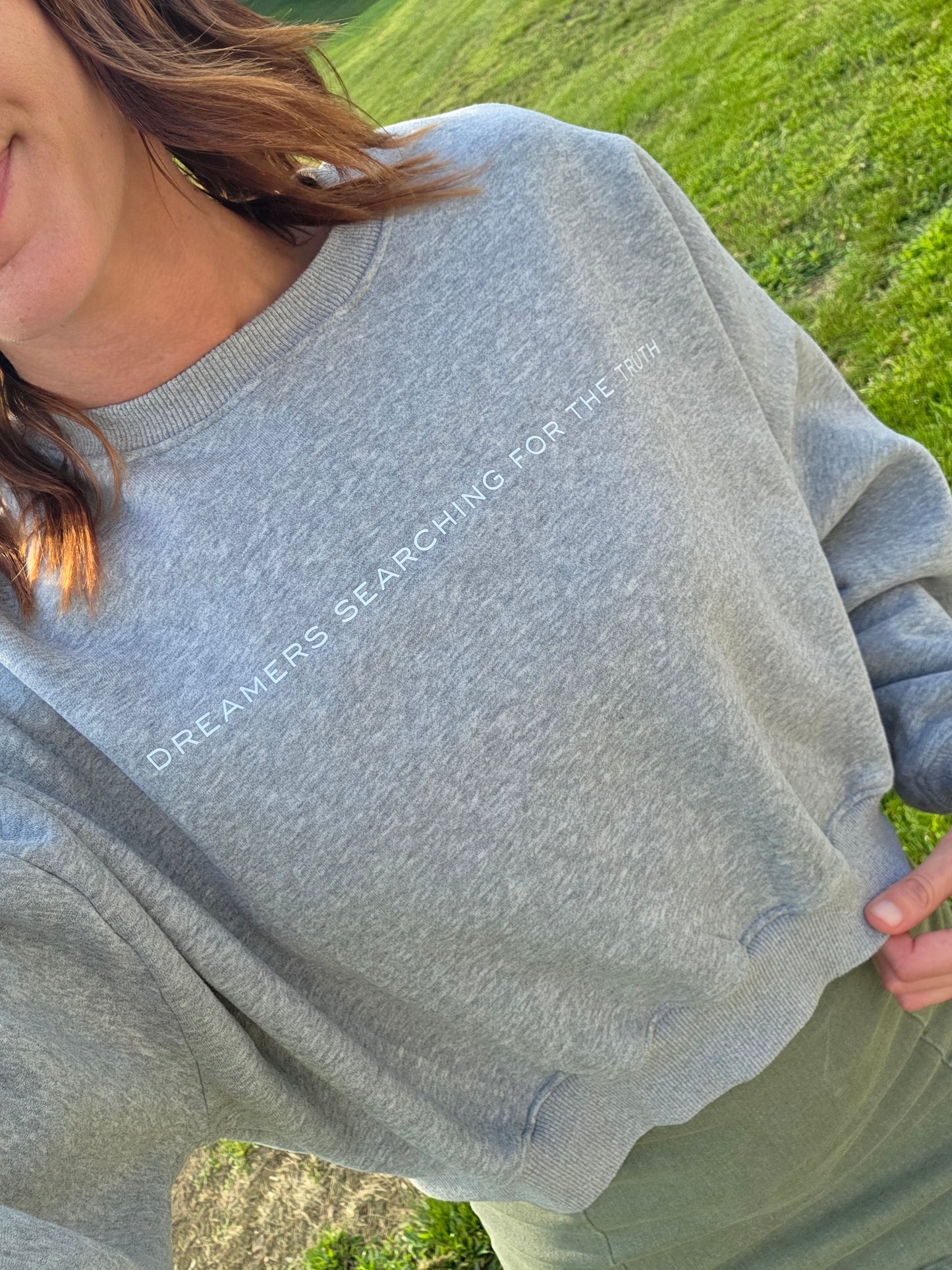 Woman wearing Dreamers Searching for the Truth oversized crop crewneck, front view selfie, showing soft fleece and fit