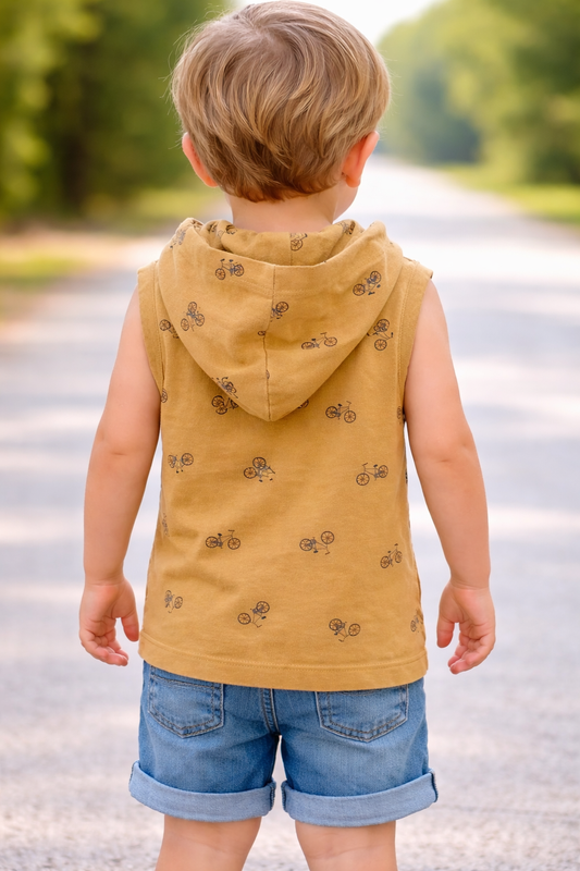 Back view of toddler model age 2–3 wearing a mustard sleeveless hooded top with bicycle print