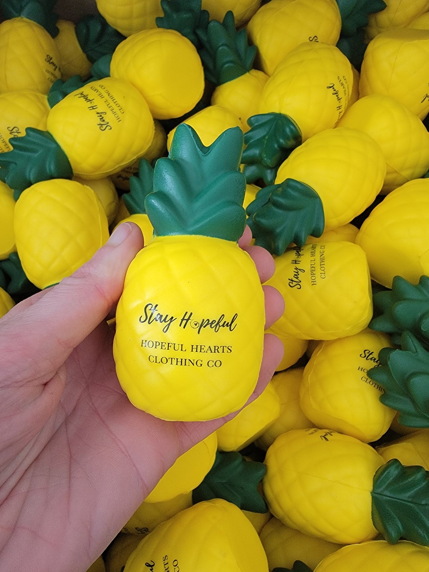 Close-up of pineapple stress ball, highlighting texture and inspirational design for stress relief and infertility suppor