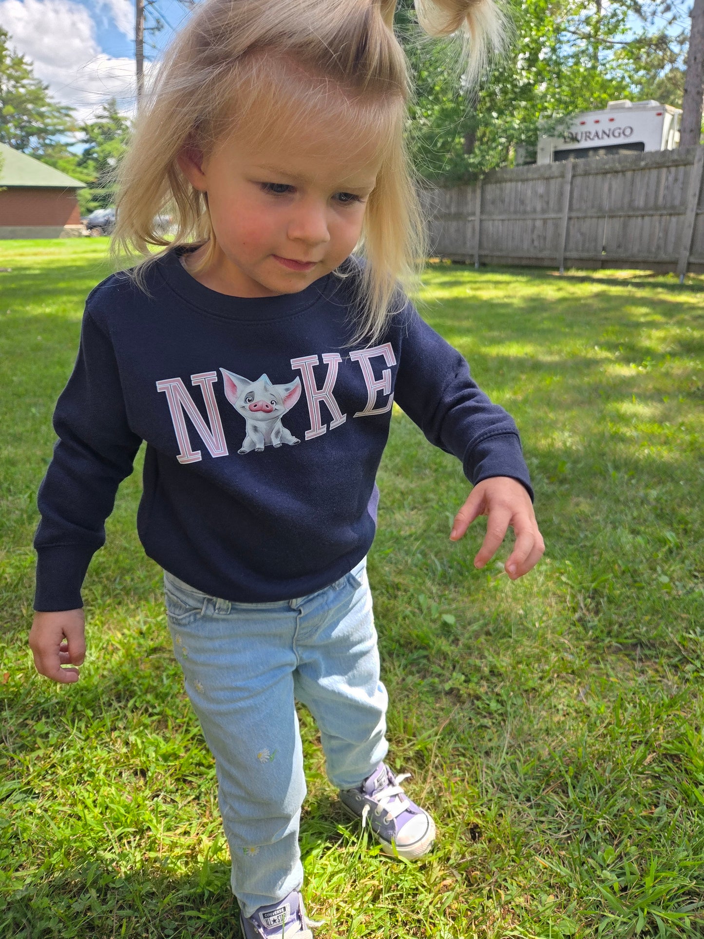 Toddler wearing Pua Crewneck inspired by Moana’s sidekick, front view highlighting soft cotton fabric and playful design