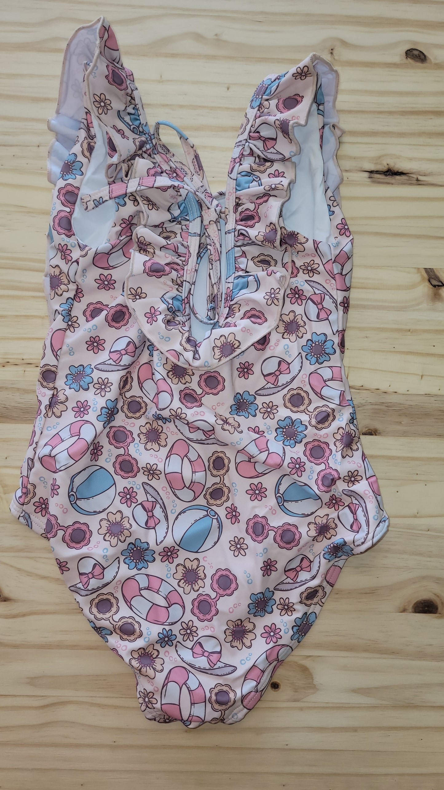 Back of girls’ pink Beach Fun swimsuit, one-piece with sun protection
