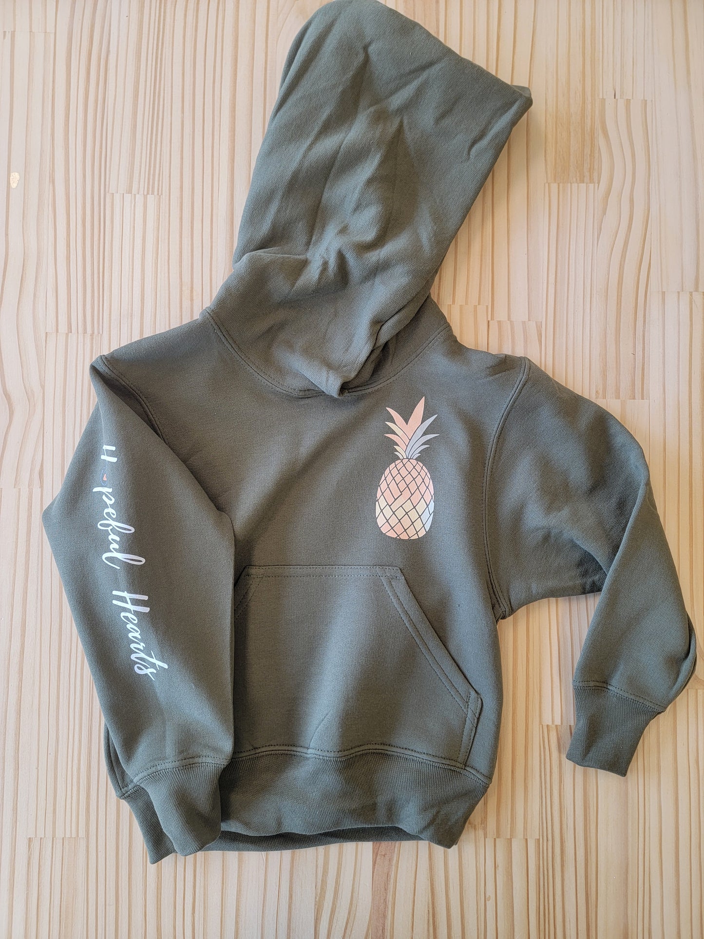 Olive green youth hoodie with pineapple logo, unisex kids pullover from Hopeful Hearts