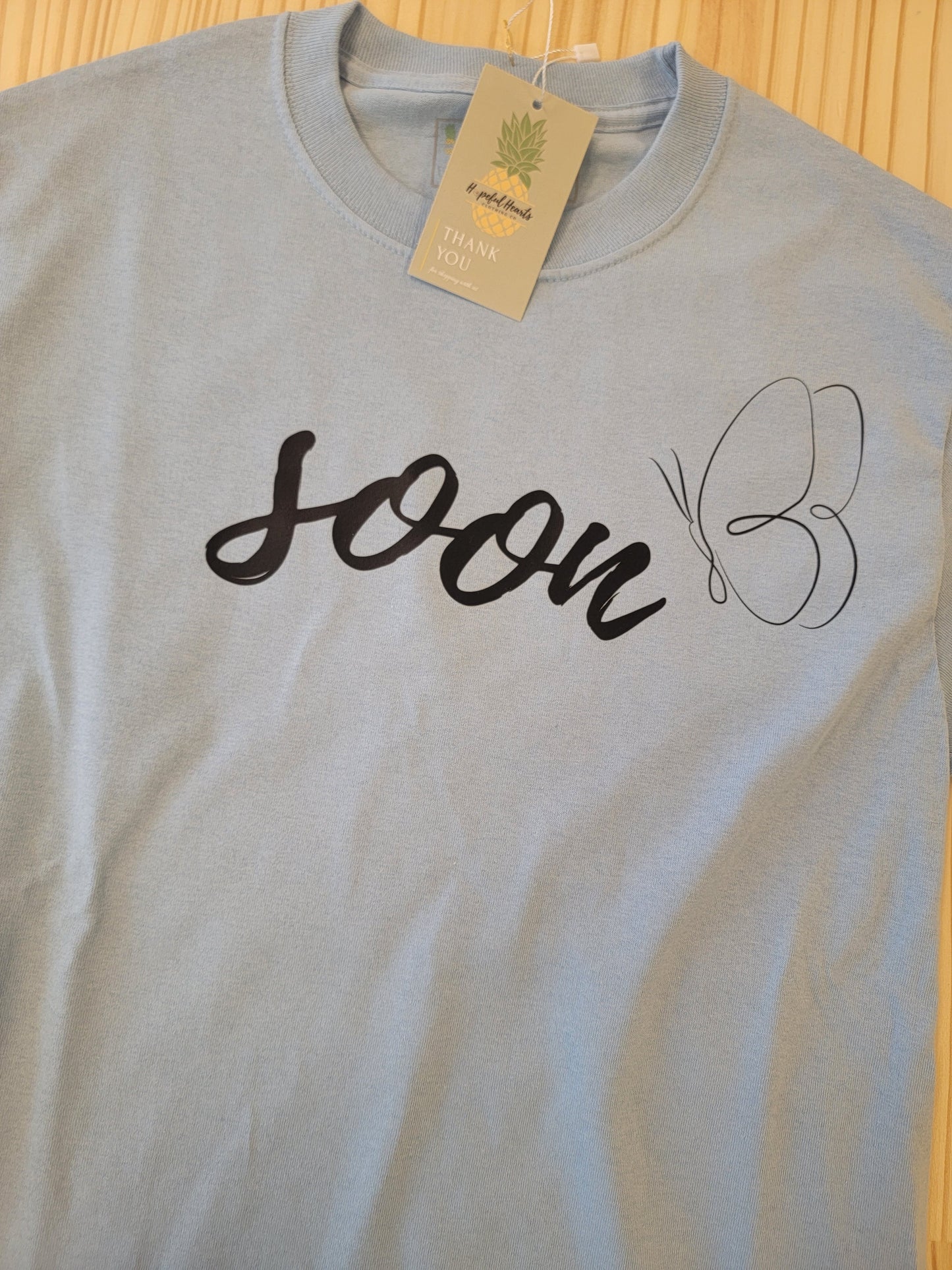 close up of ‘Soon’ butterfly, supportive tee for infertility and mental health awareness