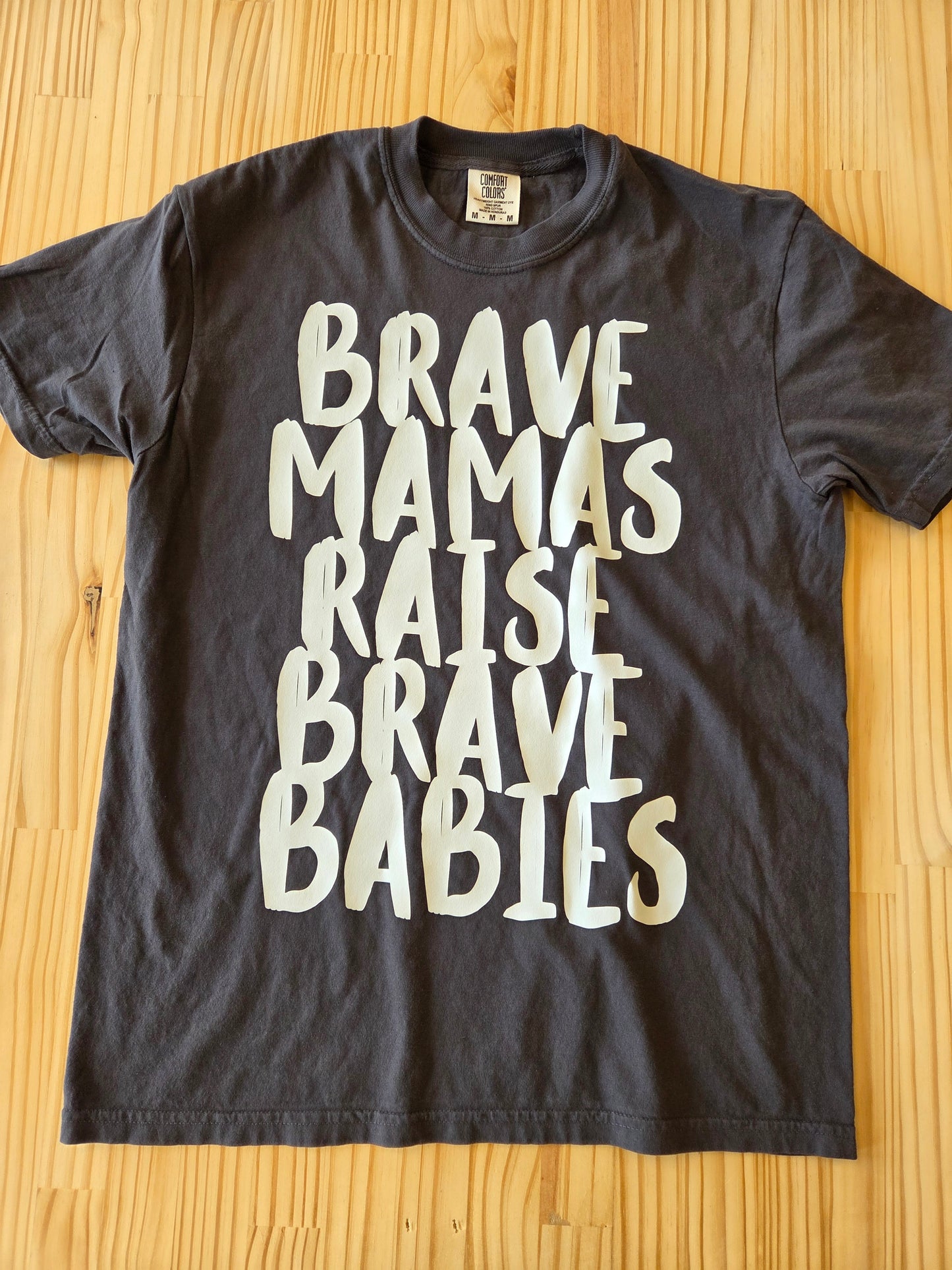 Inspirational moms’ tee in heavyweight cotton, graphic shirt promoting strength and motherhood flat lay