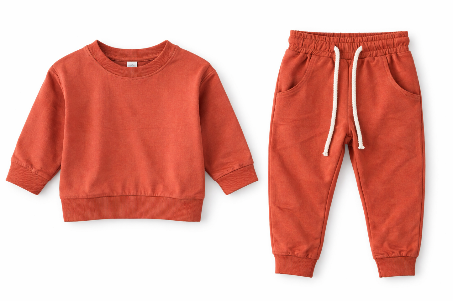 Rust baby lounge set displayed as separate pieces, featuring a soft sweatshirt and jogger pants