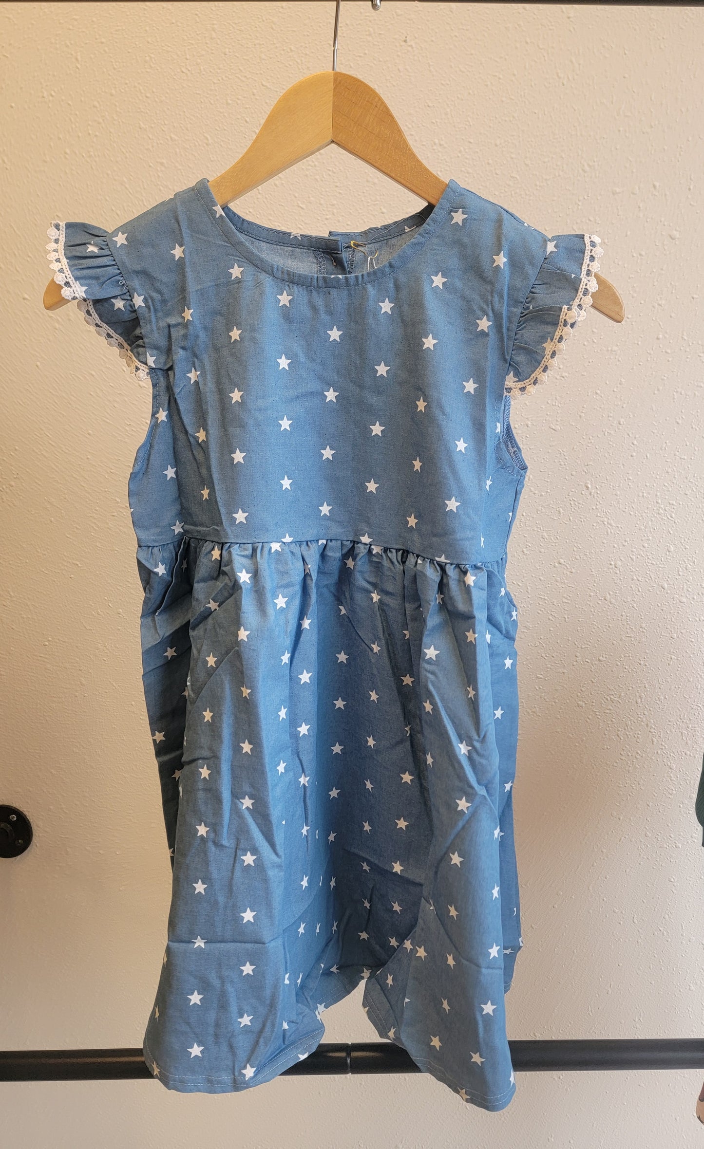 Front view of Stars Dress hanging – patriotic blue star pattern dress for toddlers and youth