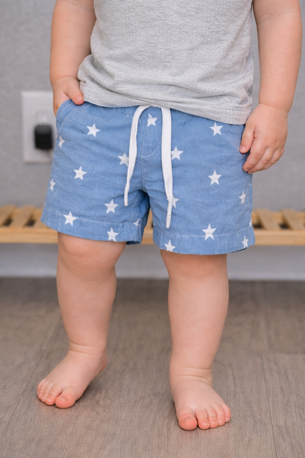 Close-up of blue star print toddler shorts with elastic waistband on 12-month-old model