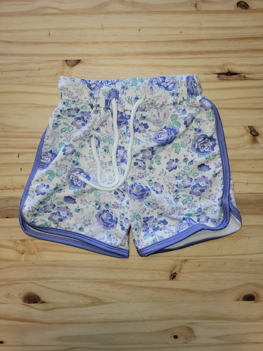 Girls drawstring shorts with purple floral print, featuring pockets