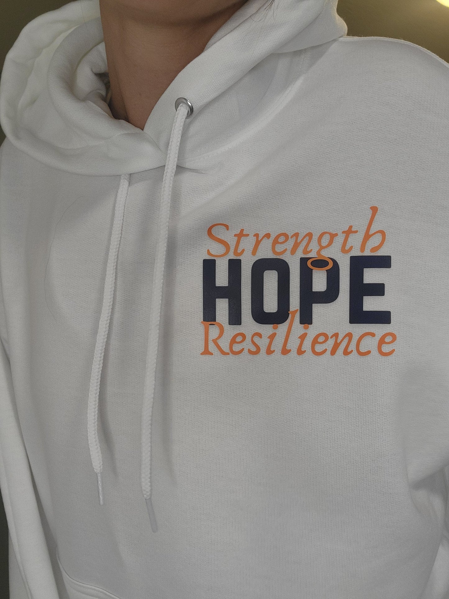 Woman wearing H.S.R. Hoodie with pineapple hope graphic, cozy unisex sweatshirt supporting infertility awareness and strength