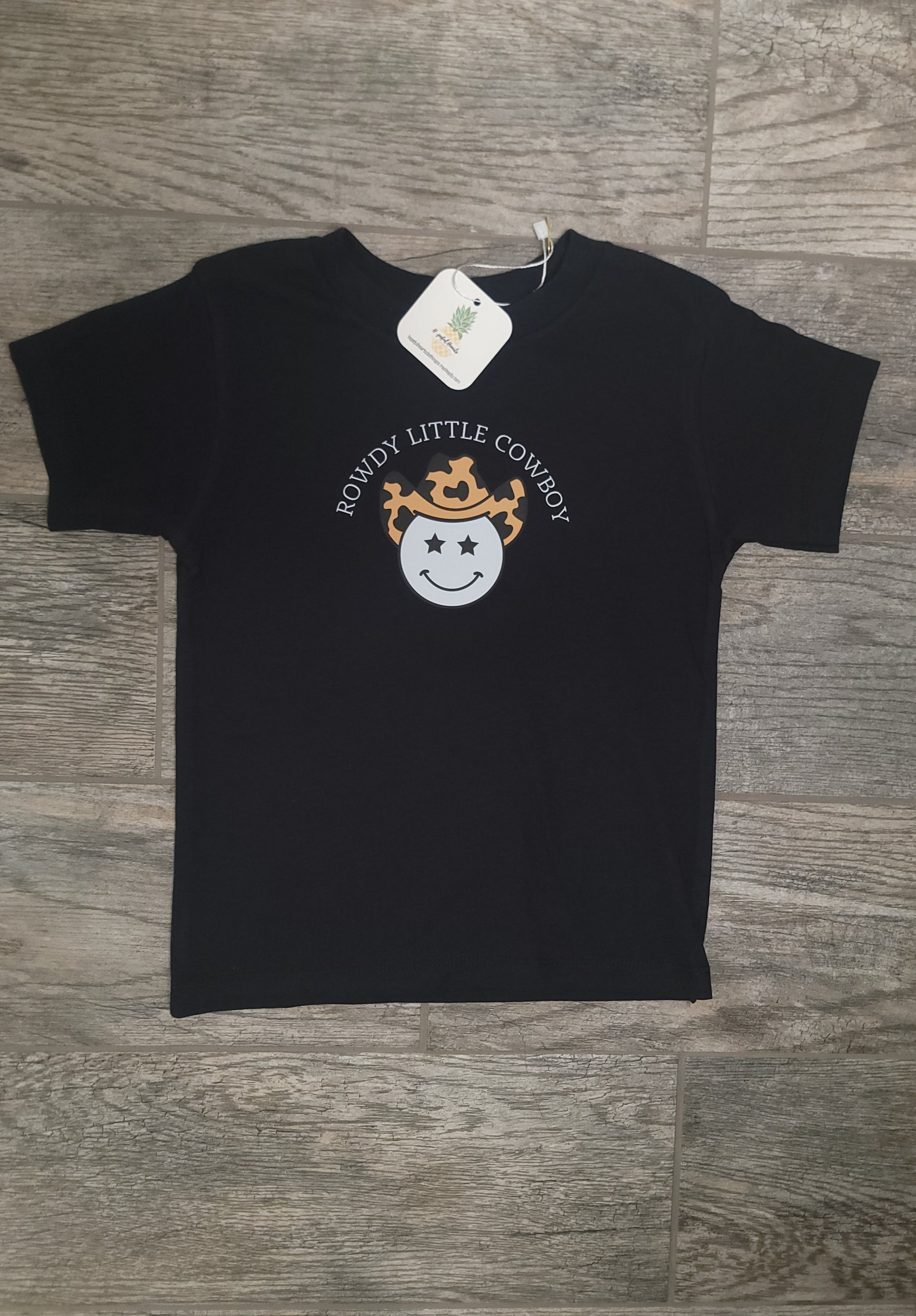 Flat lay of Rowdy Cowboy Tee for infants and toddlers, soft cotton western-themed shirt with playful cowboy graphic