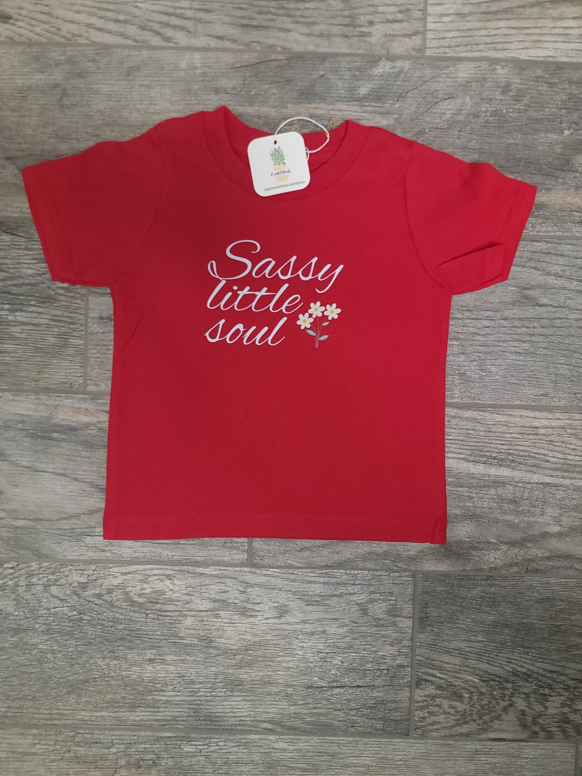 Flat lay of red Sassy Little Soul Tee, playful infant and toddler shirt with bold graphic design