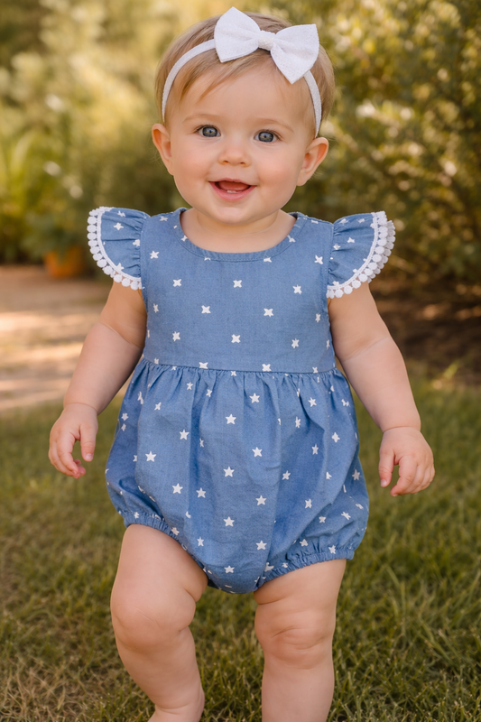 Baby wearing blue star print romper with flutter sleeves, size 6–18 months