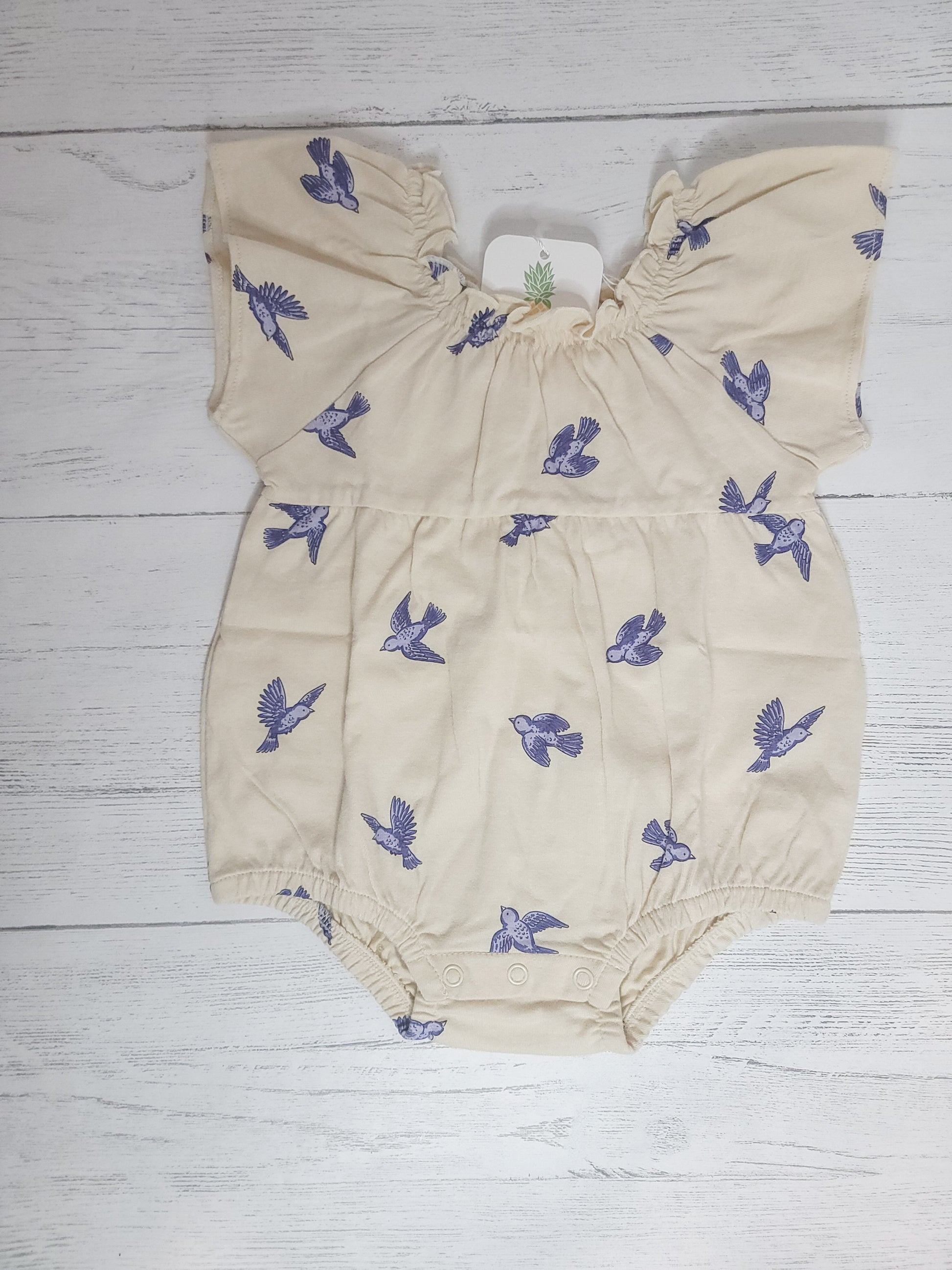 Flat lay of Bluebird Flutter Sleeve Romper for toddler & infant girls, showing design, color, and cotton fabri