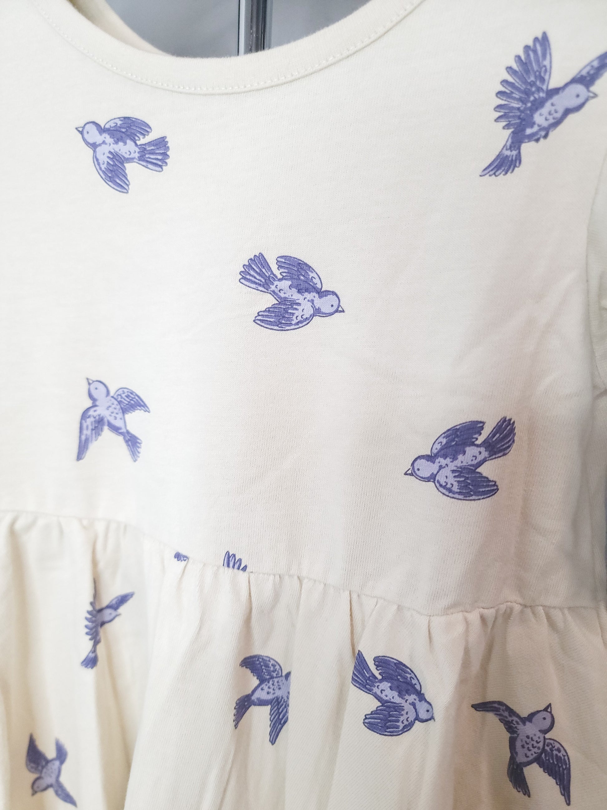 Close-up of Bluebird Twirl Dress for toddler girls, showing cotton fabric, stitching, and twirl-friendly skirt detail