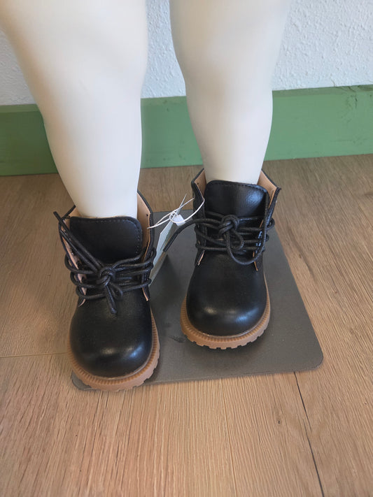 Black unisex toddler and youth combat boots on mannequin, front view, lace-up style