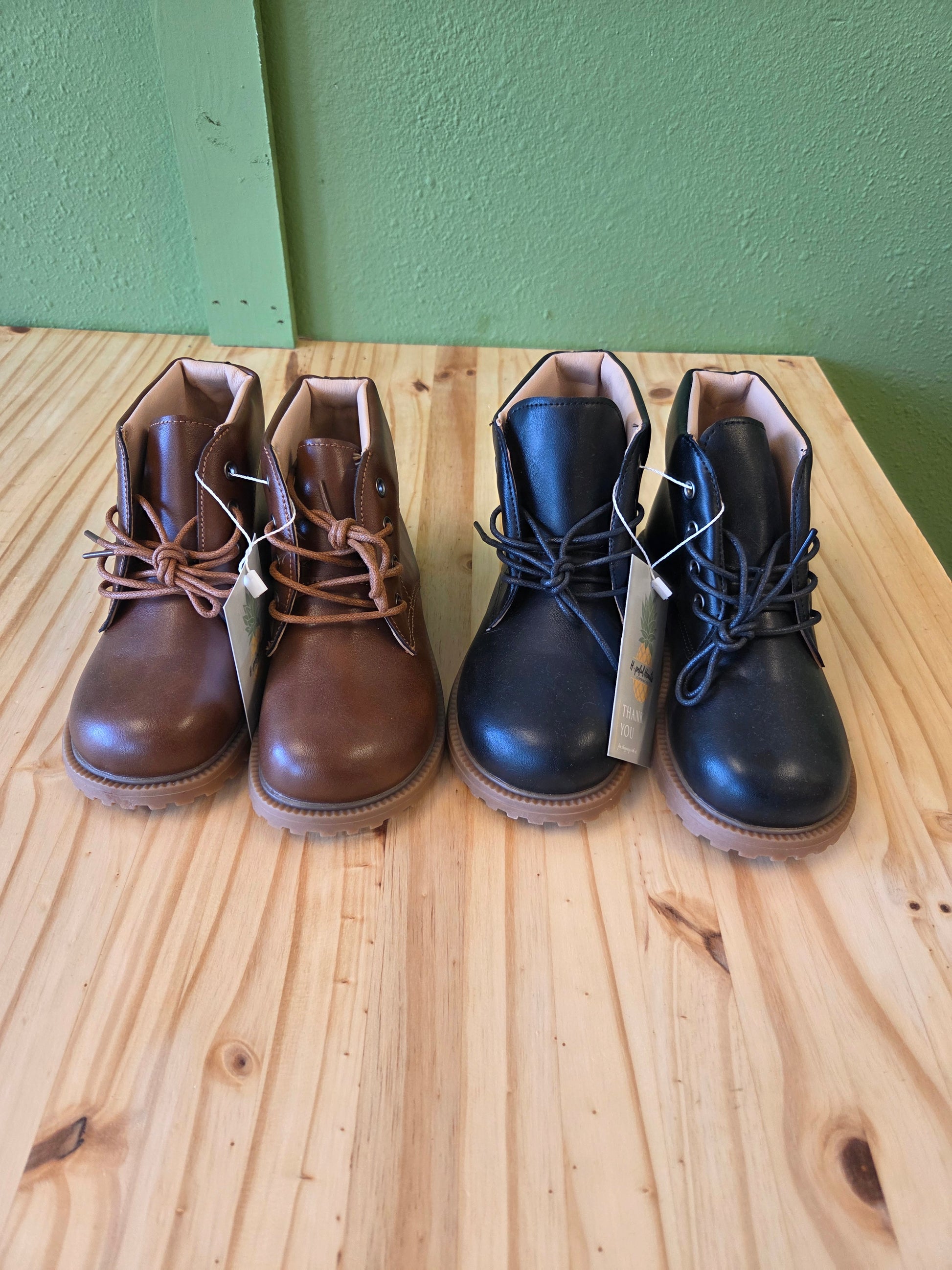 Unisex toddler and youth combat boots in black and brown, front view, stylish lace-up design