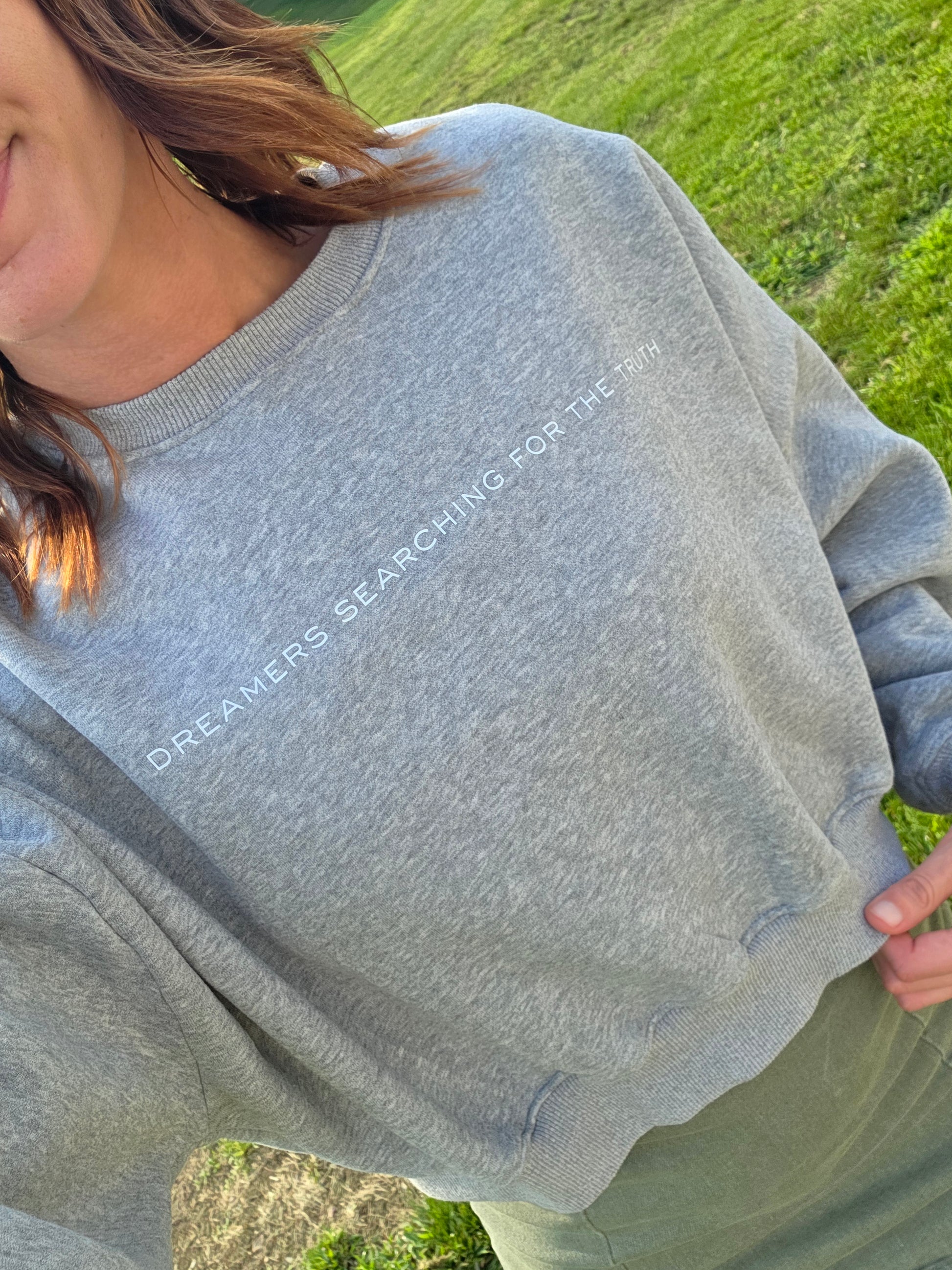 Woman wearing Dreamers Searching for the Truth oversized crop crewneck, front view selfie, showing soft fleece and fit