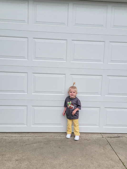 Toddler wearing Green Bay Packers Toddler Tee in green and gold, showing football fan style and team pride