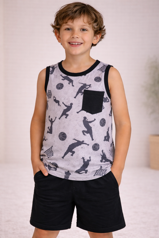 Child wearing a gray basketball silhouette print sleeveless tank with black trim and black chest pocket, paired with solid black shorts, standing in a neutral studio setting.