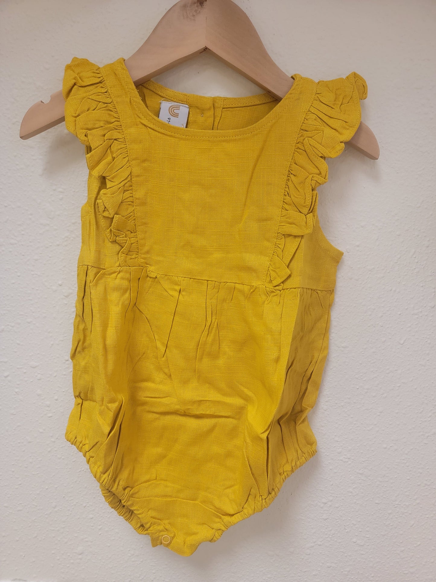 Front view of Josie linen romper in mustard – stylish lightweight baby and toddler outfit