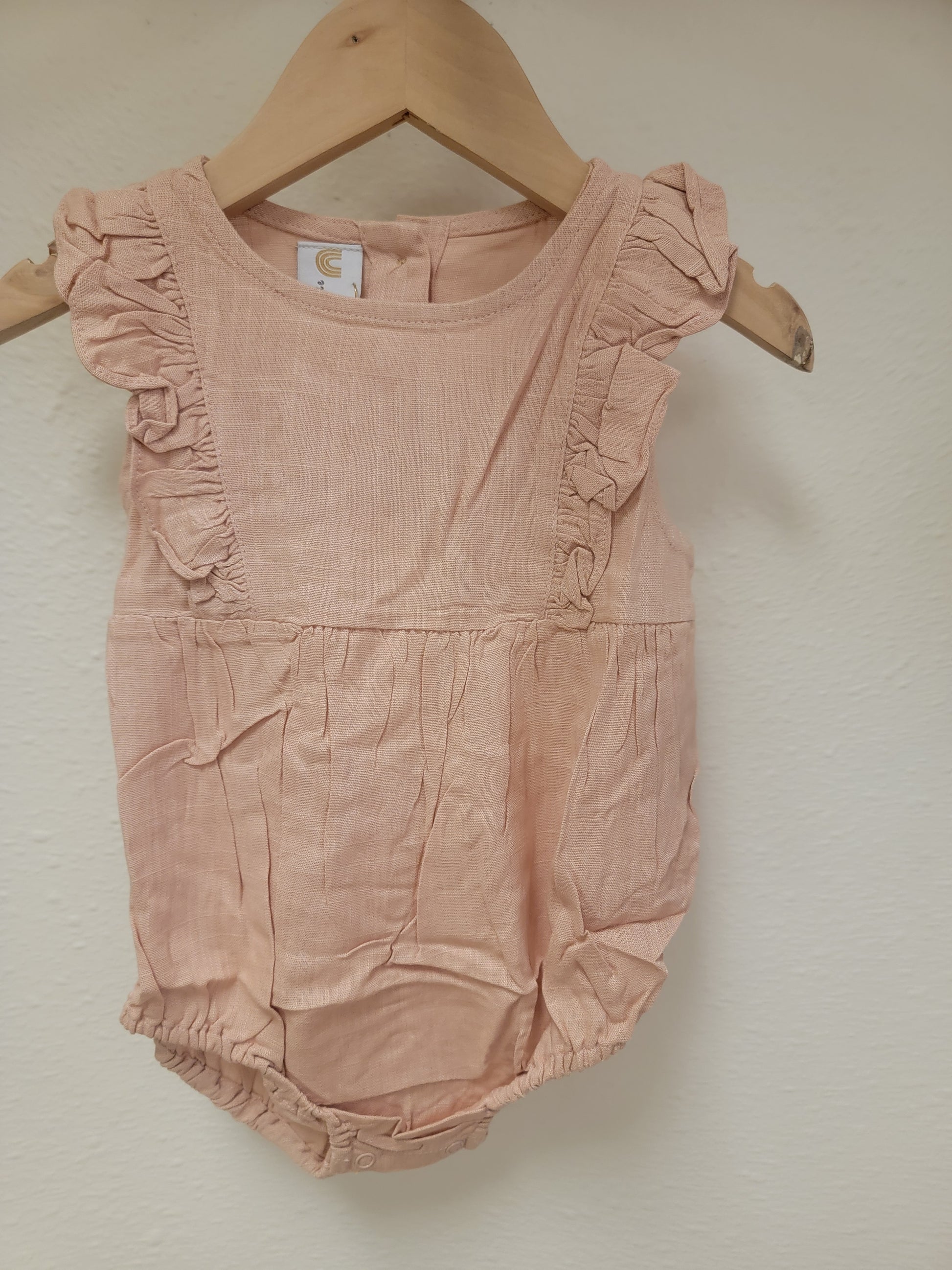 Front view of Josie linen romper in peach – lightweight stylish outfit for baby girls and toddlers