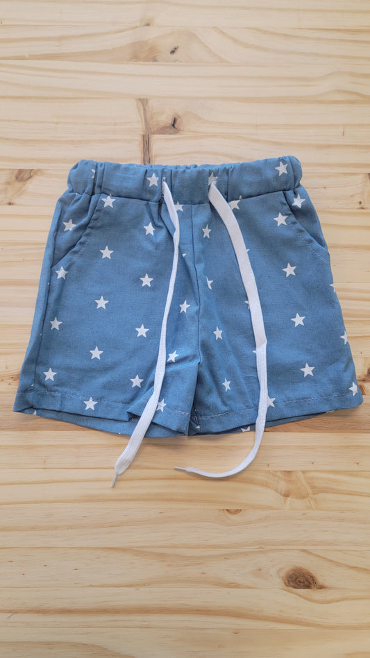 Flat lay of kids’ patriotic star shorts – lightweight red, white, and blue summer shorts for 4th of July
