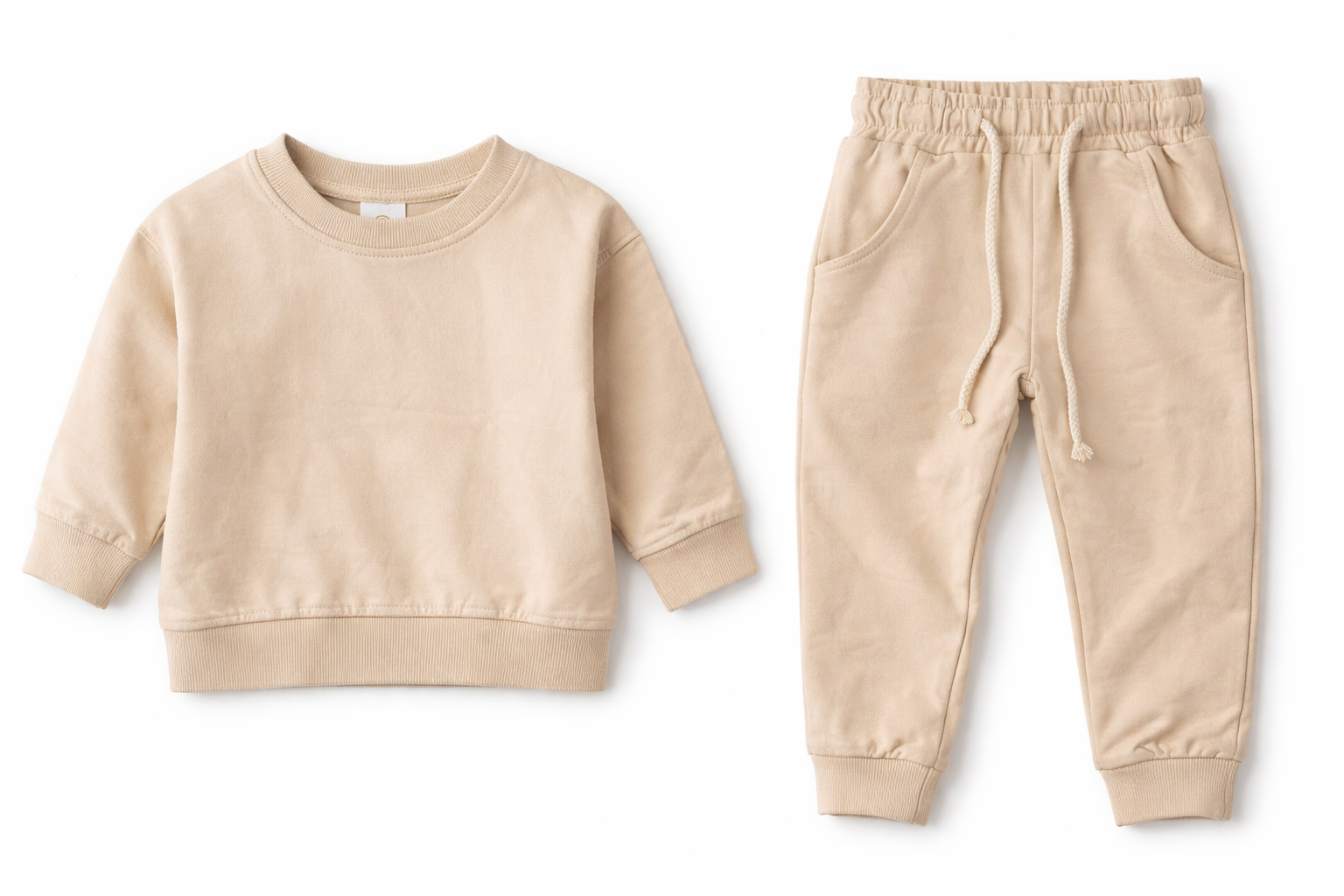 Neutral baby lounge set displayed as separate pieces, featuring a soft sweatshirt and jogger pants