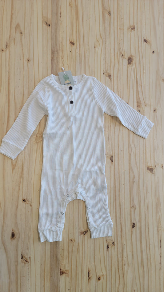 Flat lay of ribbed white long sleeve baby romper – modern minimalist toddler clothing