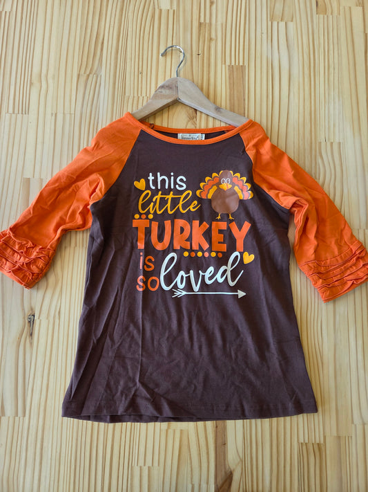 Girls’ long sleeve Thanksgiving shirt with ruffle sleeves and cute little turkey graphic