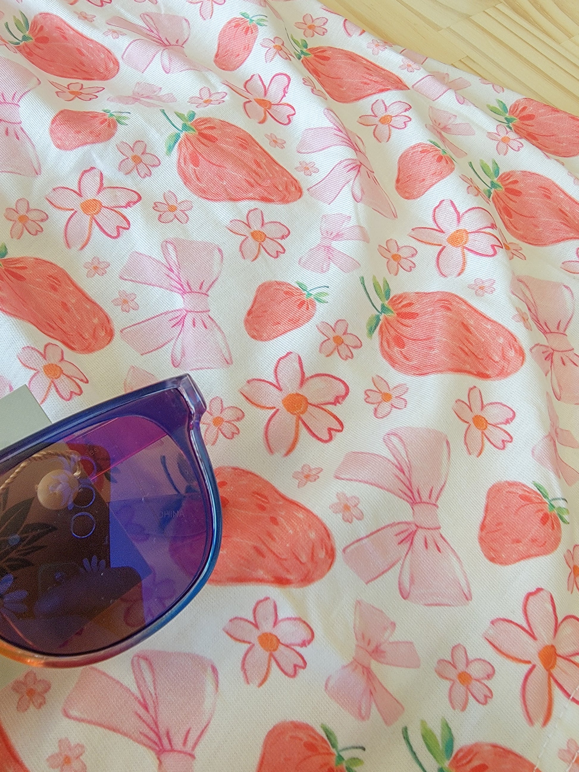 Youth dress featuring strawberry pattern and pink bow, soft and stylish summer outfit for girls