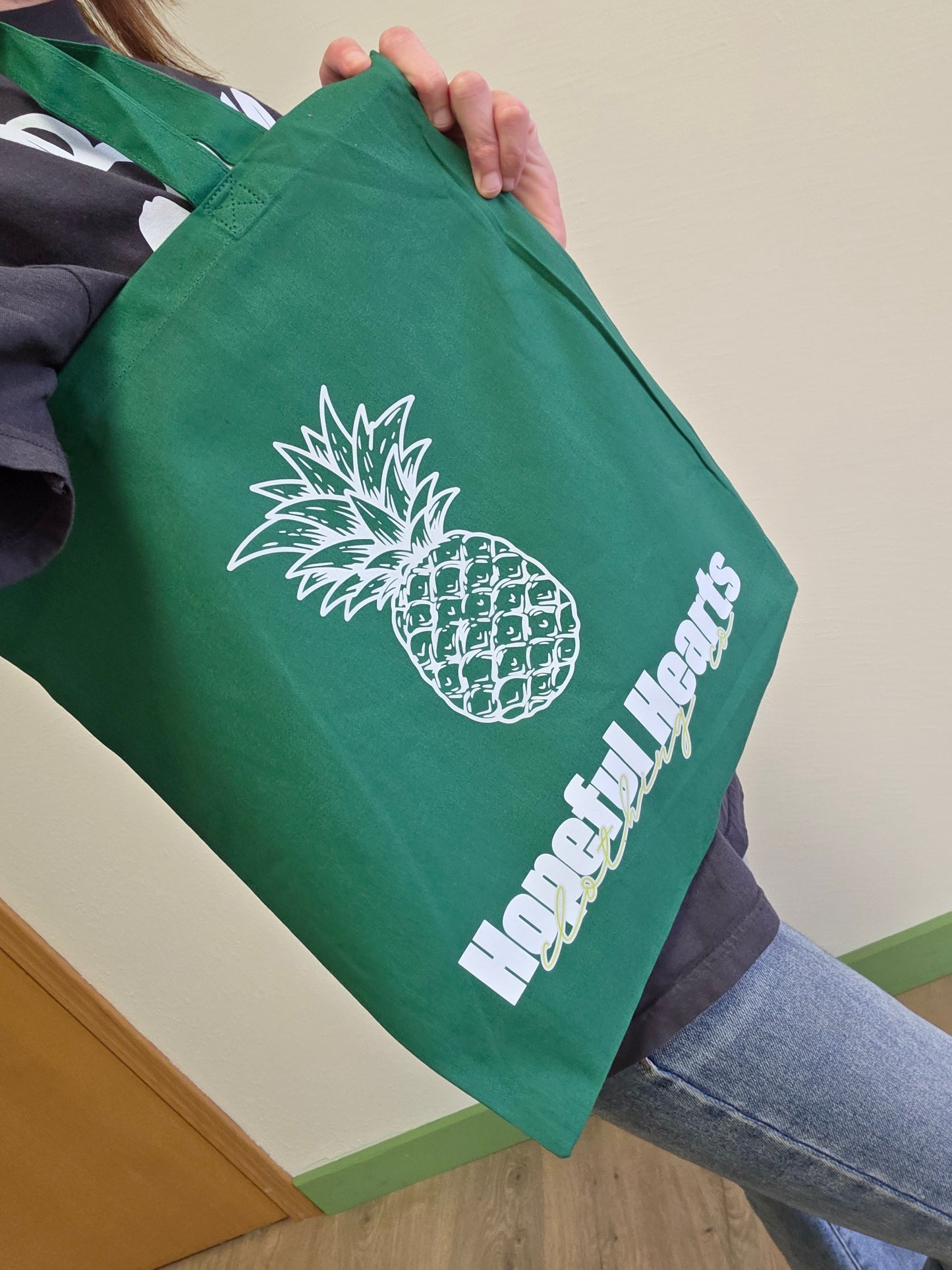 Reusable canvas tote featuring green pineapple design, sustainable shopping bag from Hopeful Hearts