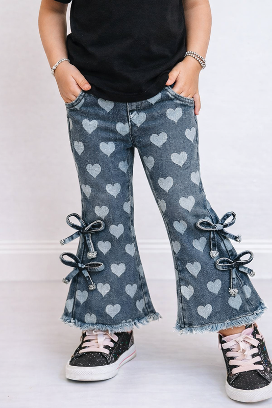 Close-up of toddler heart bell bottom pants showing heart pattern, bow side ties, and flared leg detail