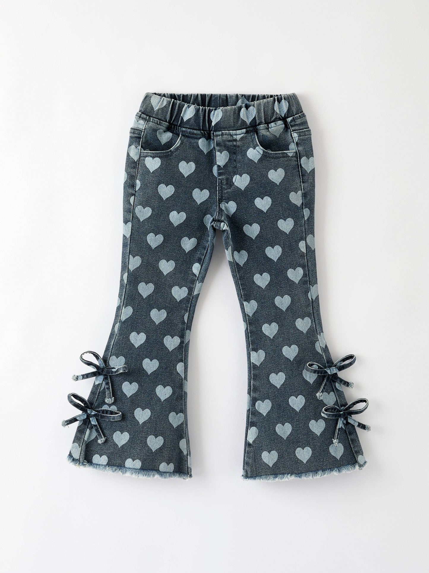 Flat lay of toddler heart print bell bottom pants with bow details and elastic waistband