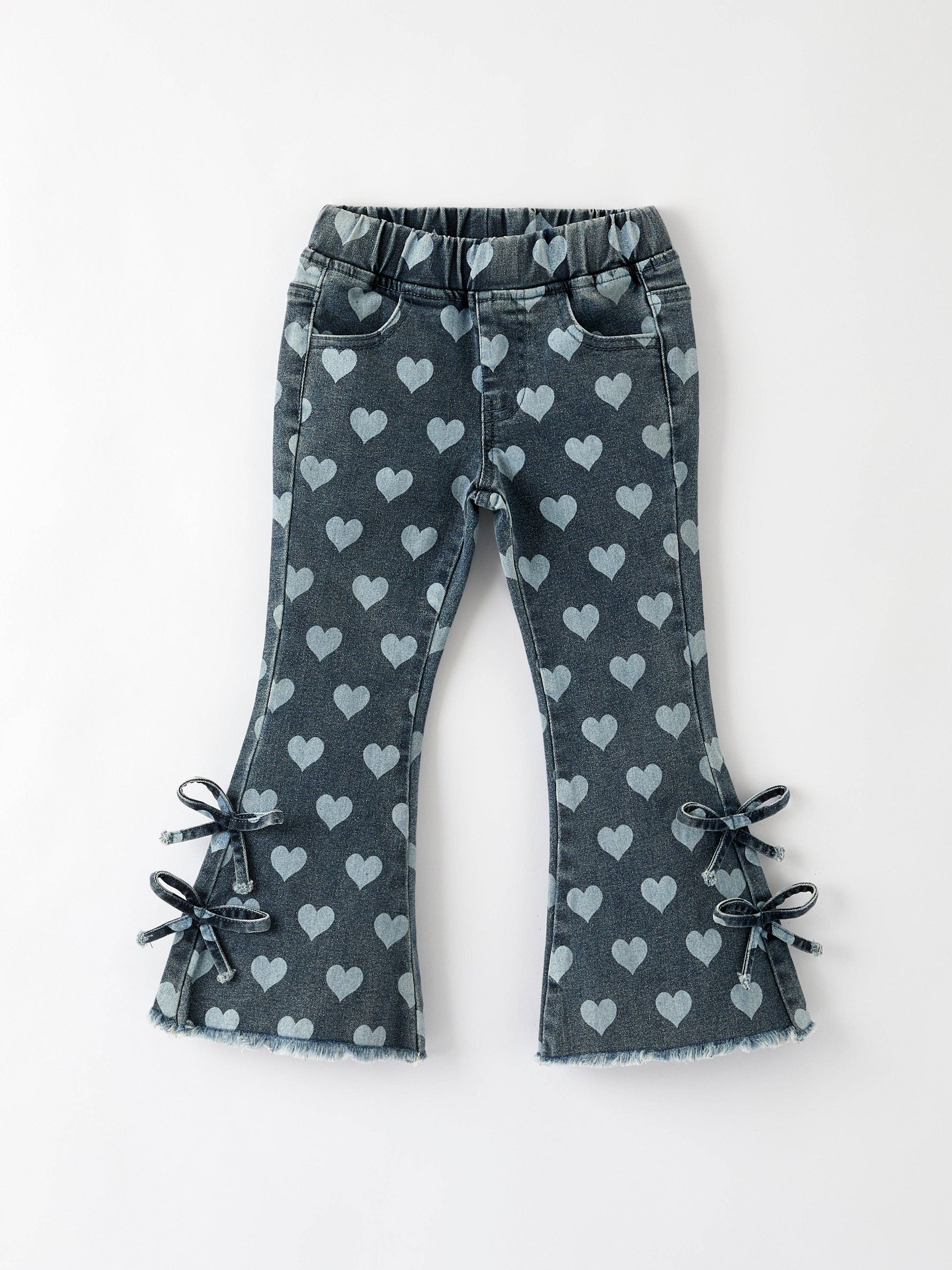 Flat lay of toddler heart print bell bottom pants with bow details and elastic waistband