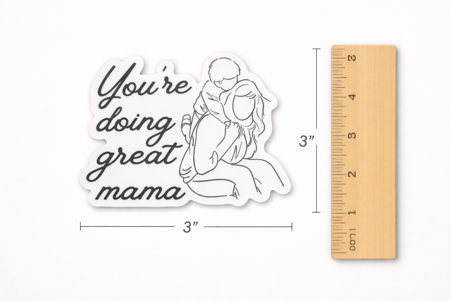You’re Doing Great Mama vinyl sticker shown next to a ruler for size reference, approximately 3 inches wide.