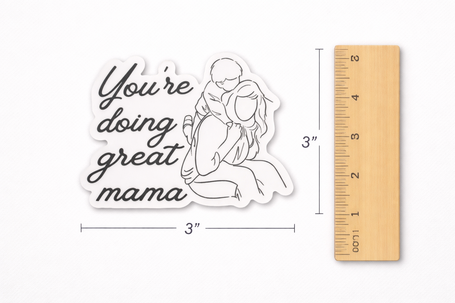 You’re Doing Great Mama vinyl sticker shown next to a ruler for size reference, approximately 3 inches wide.